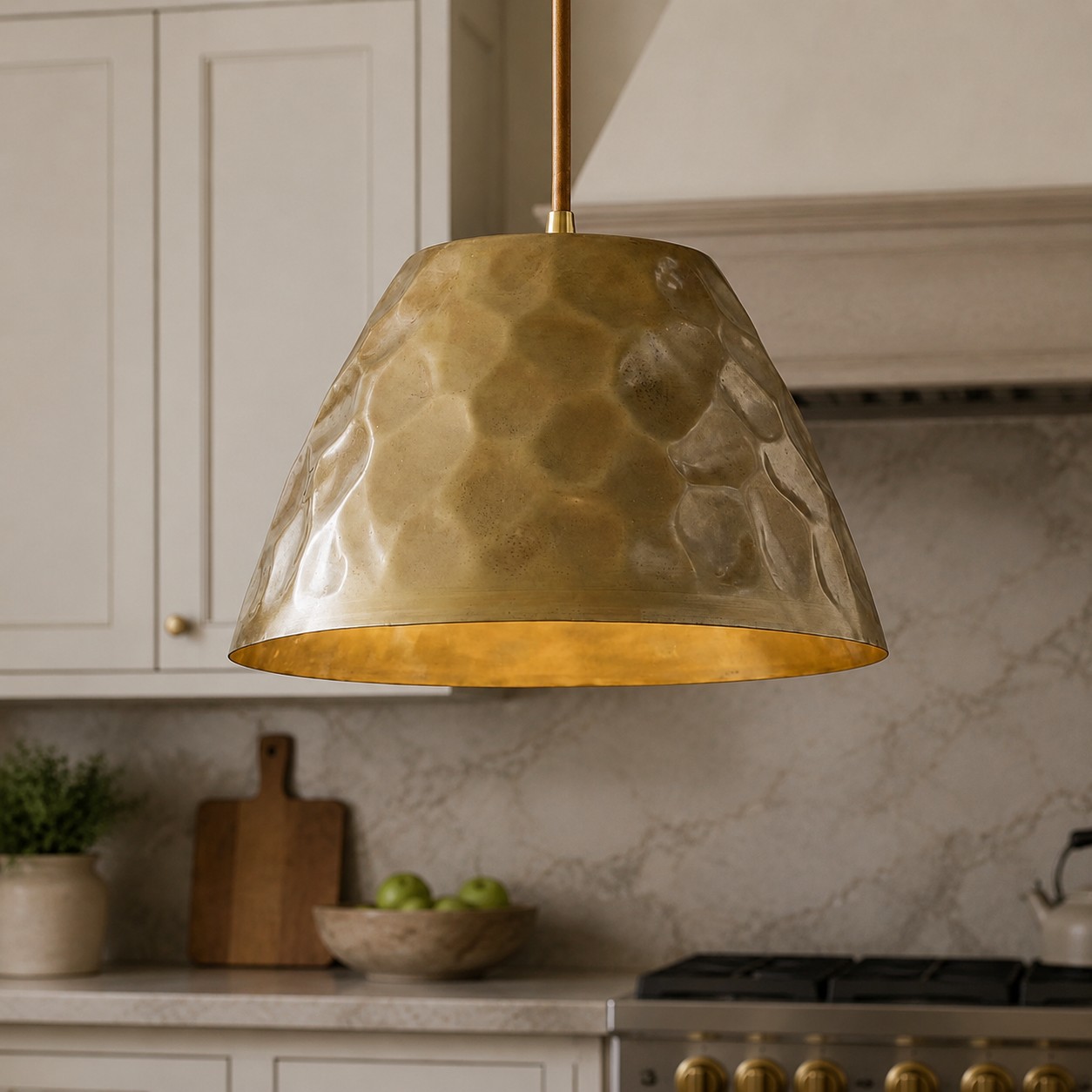 Hammered brass pendant above a kitchen island