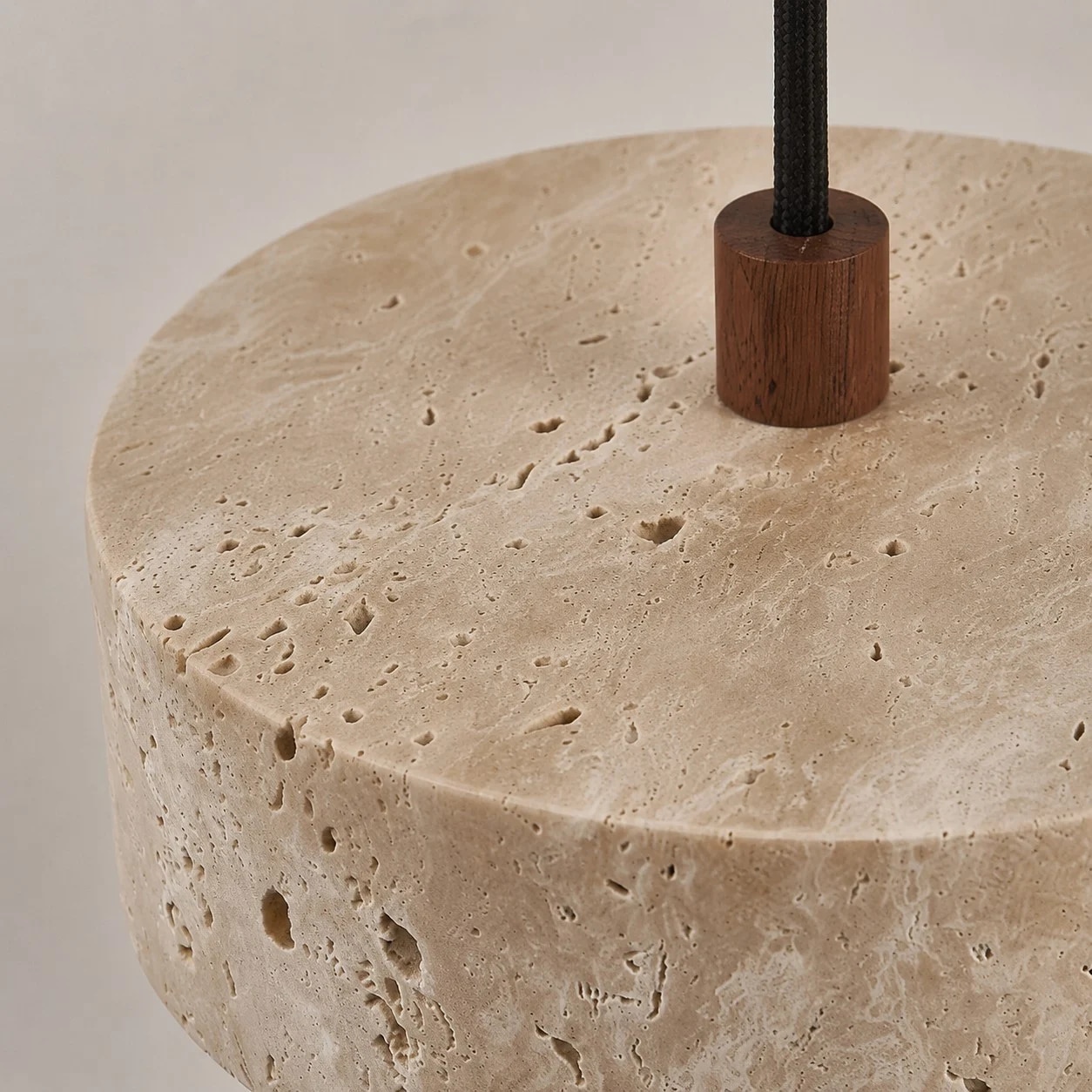 close view of natural travertine stone texture and walnut wood connector