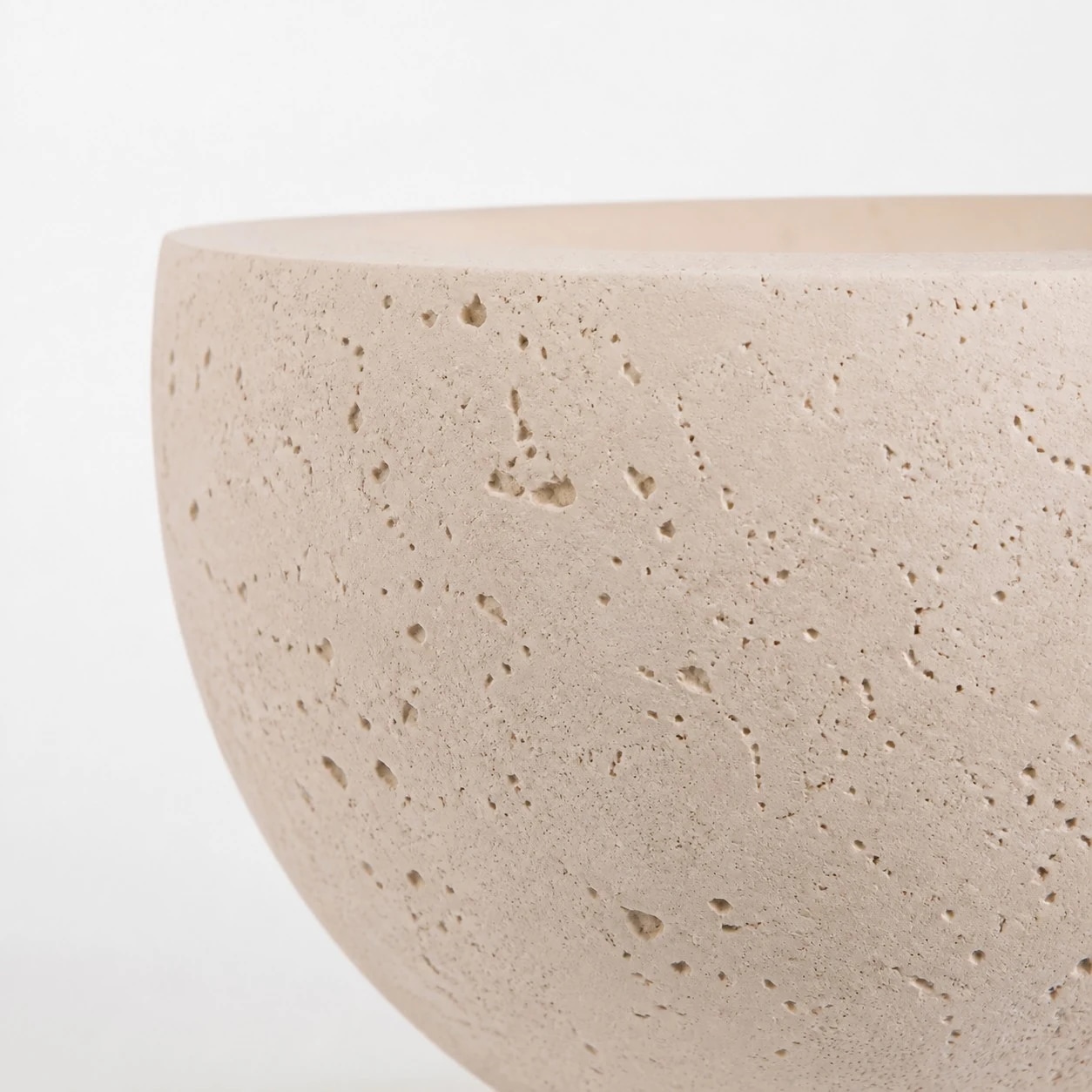 Curved rim and stone-style surface of wall light