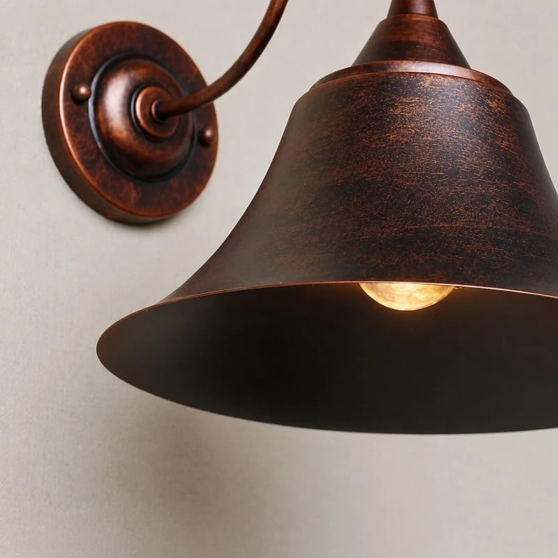 Close view of the rust finish shade and wall canopy