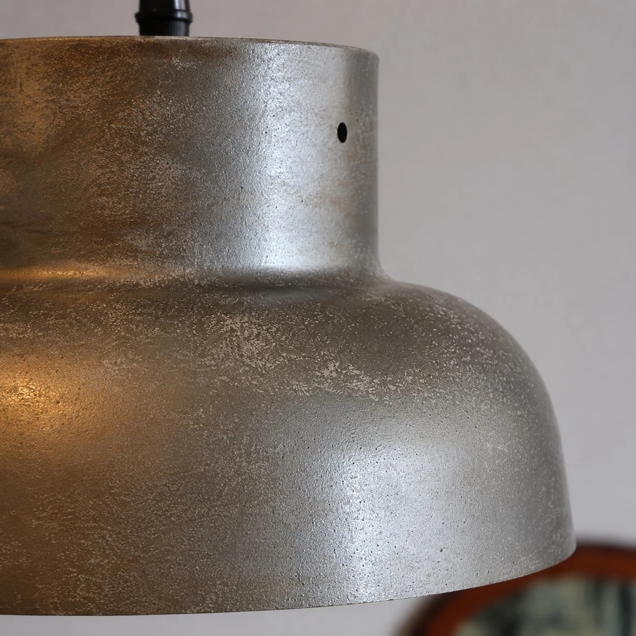 Gros plan sur la texture de l'abat-jour en métal gris argenté vieilli