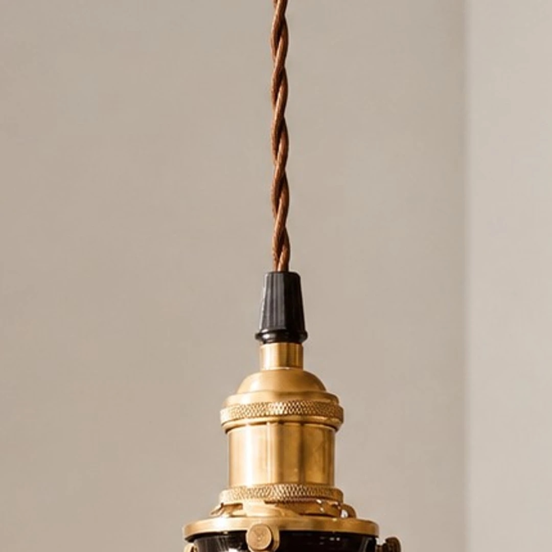 Close view of the copper lamp body and twisted cord