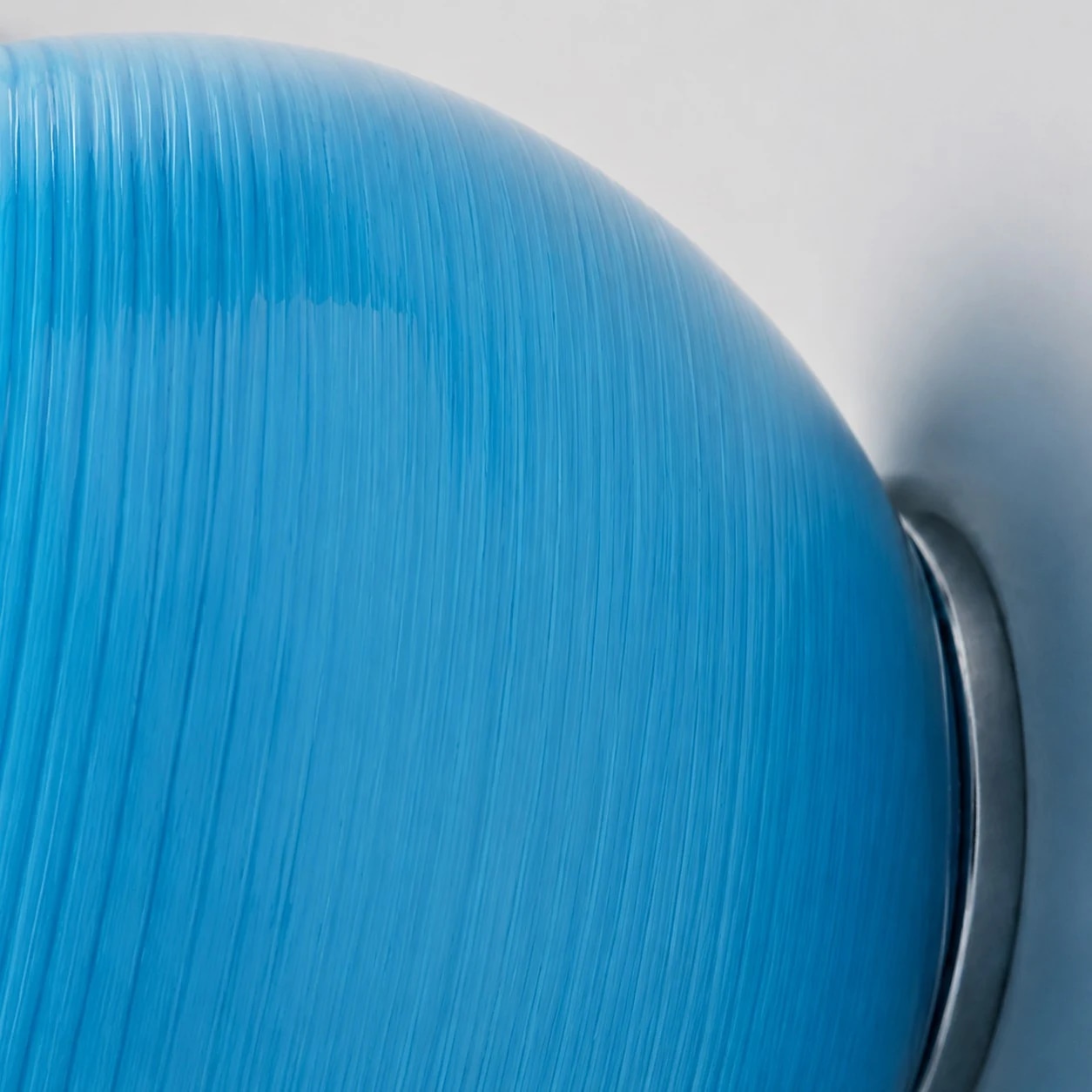 Blue glass edge and wall mount detail