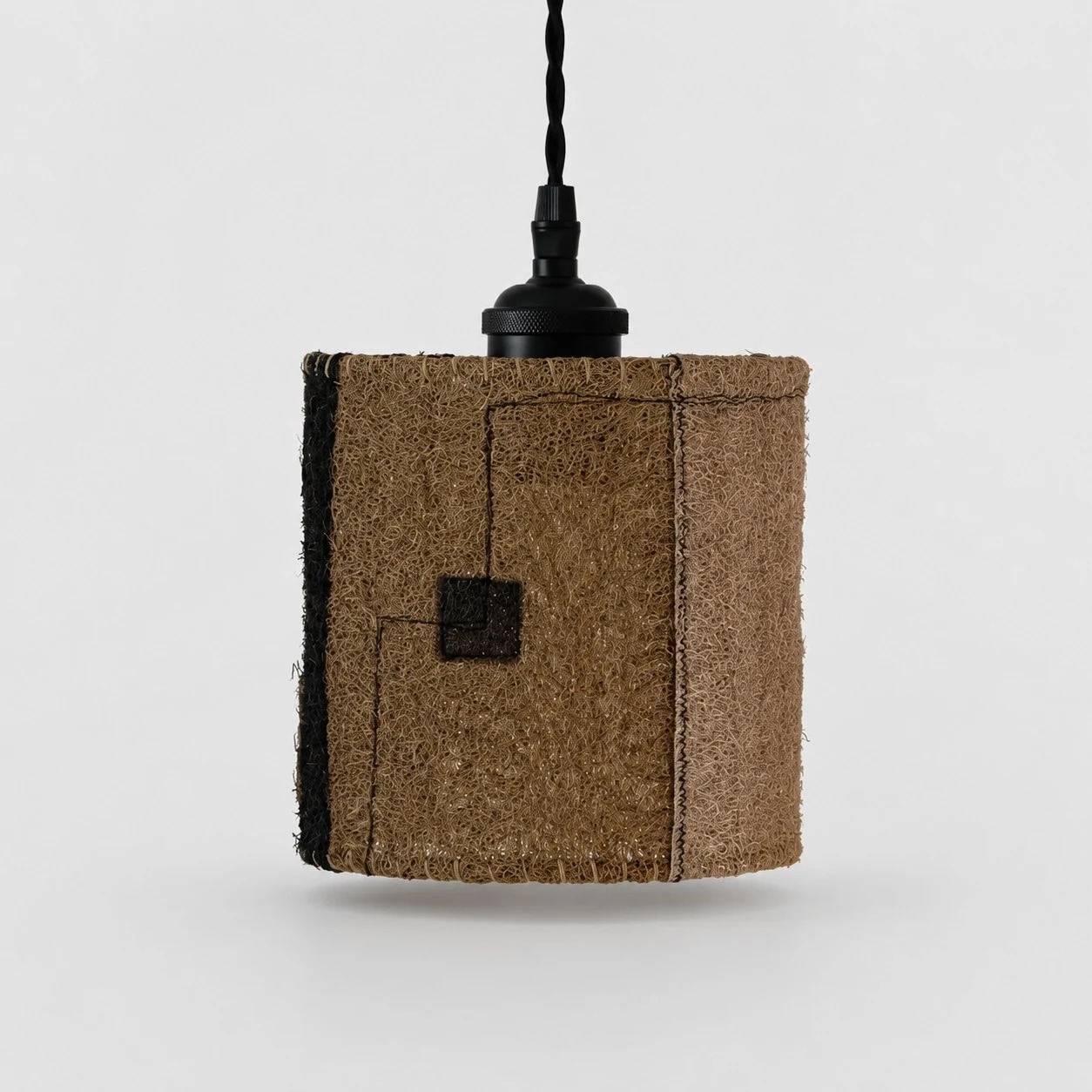 Petite lampe suspendue en luffa naturel sur fond blanc