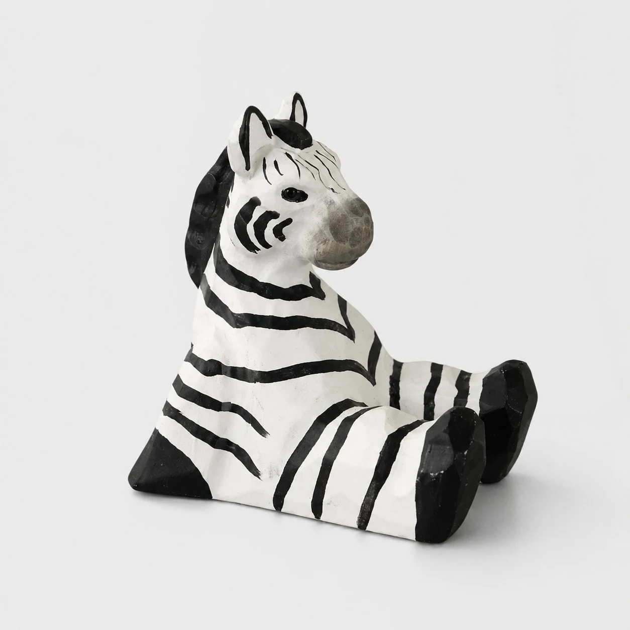 Supporto per telefono in legno intagliato a mano a forma di zebra.