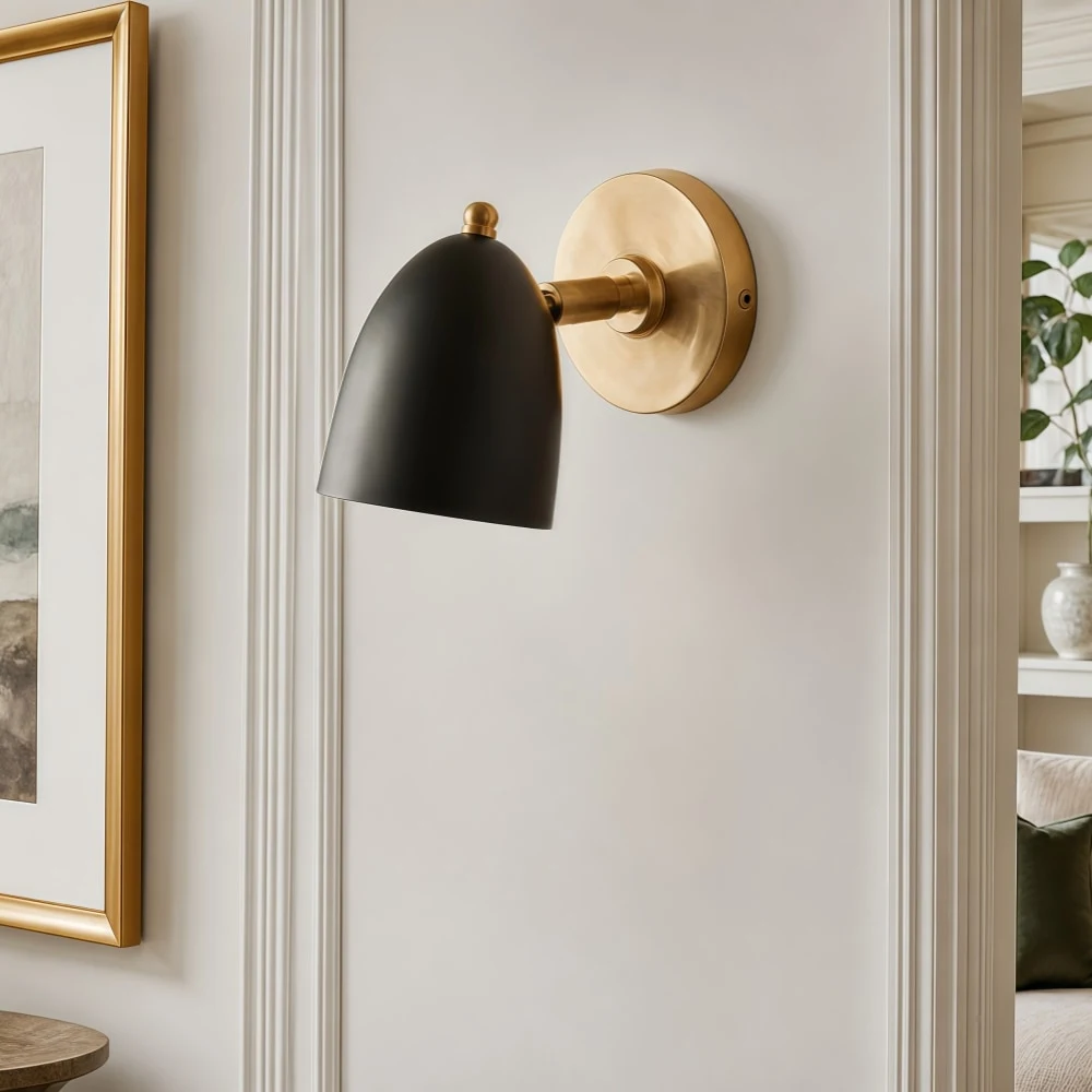 Black and gold wall sconce in a refined wall setting