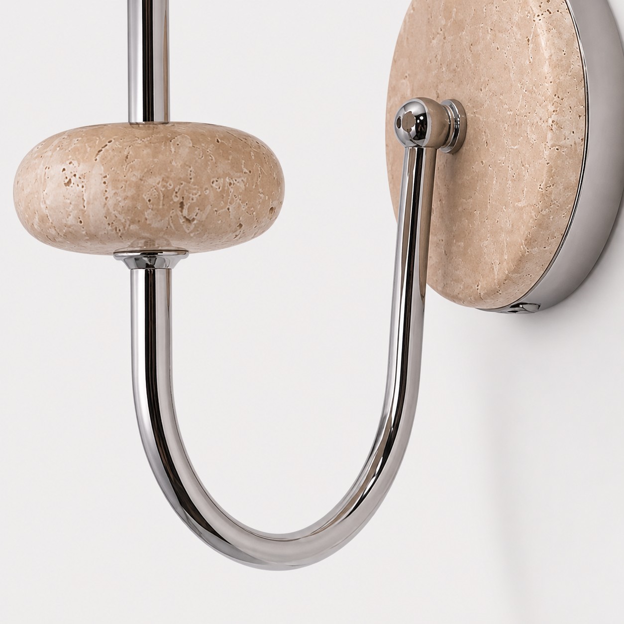 Detail: Arm aus poliertem Chrom und Wandplatte aus Naturstein