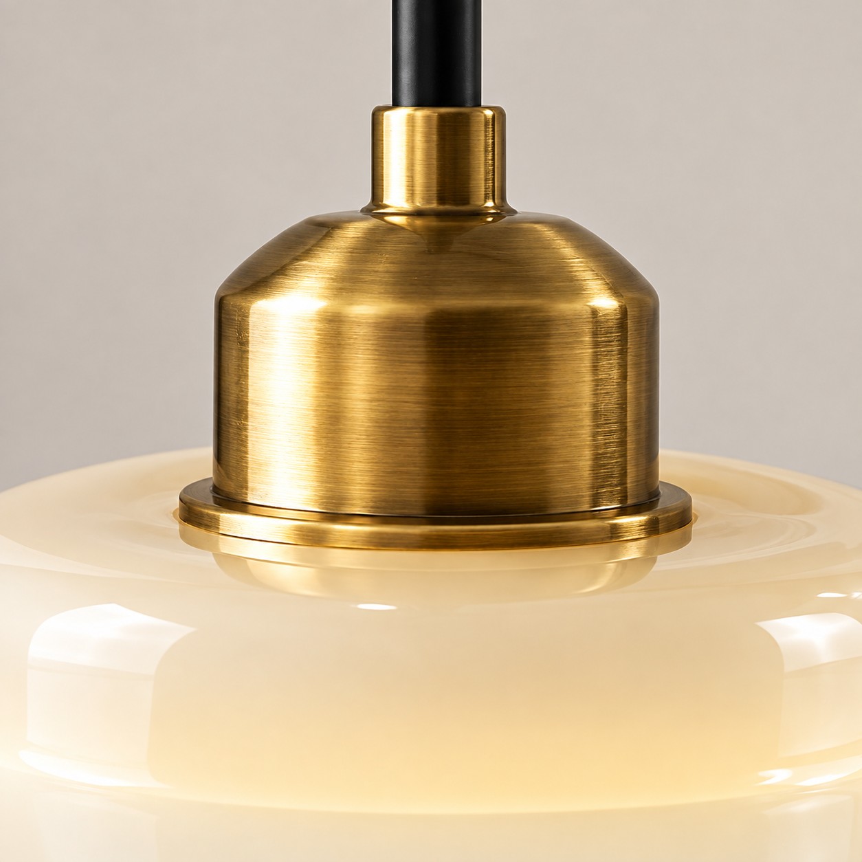 Close-up of brushed brass fitting above the glass shade