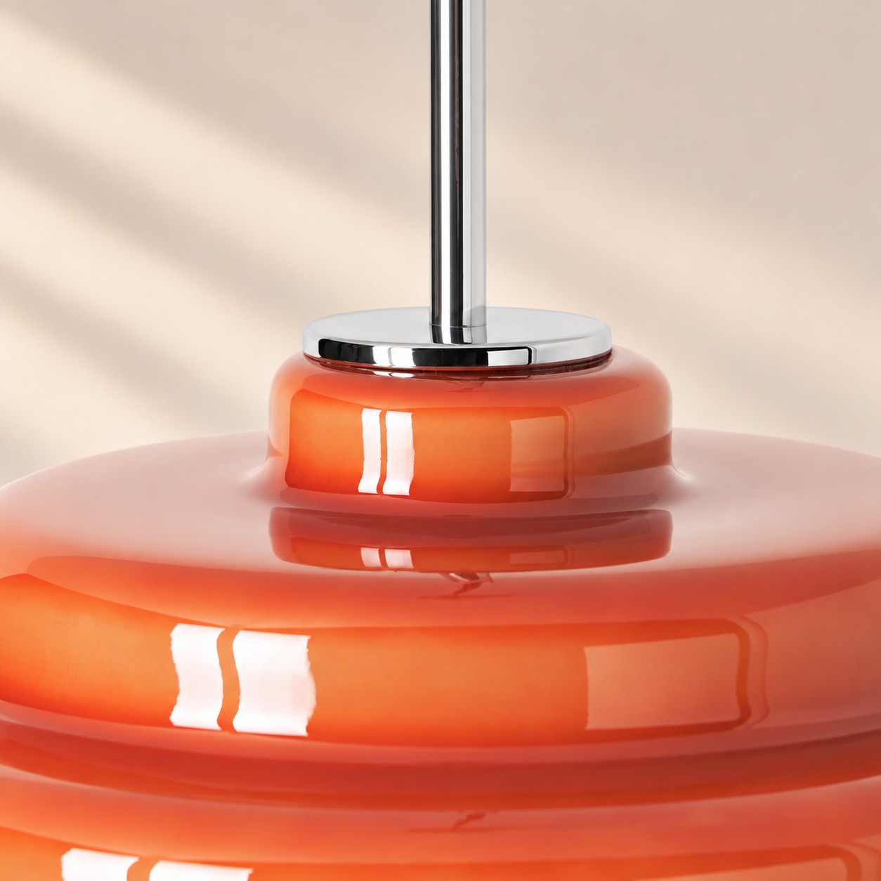Close-up of chrome metal join on glass pendant