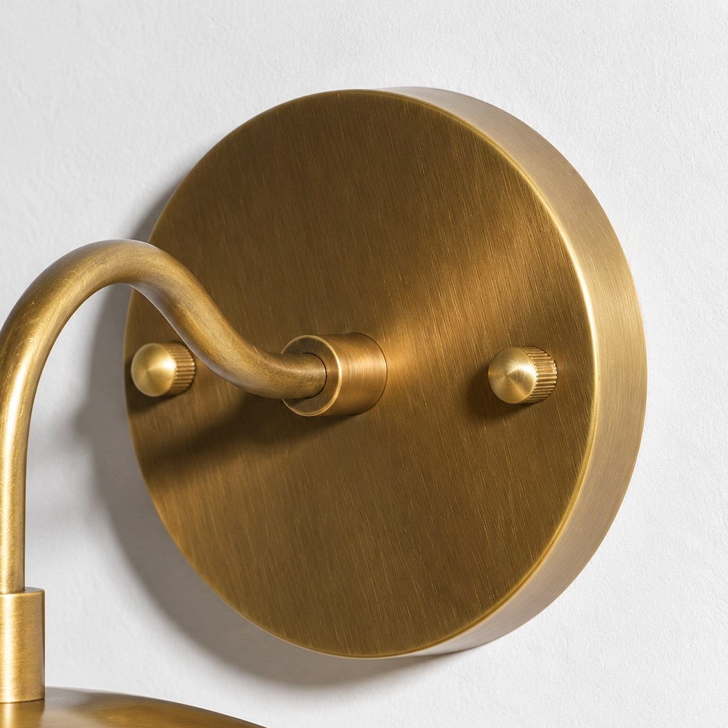 Close detail of the frosted opal glass globe on the wall lamp