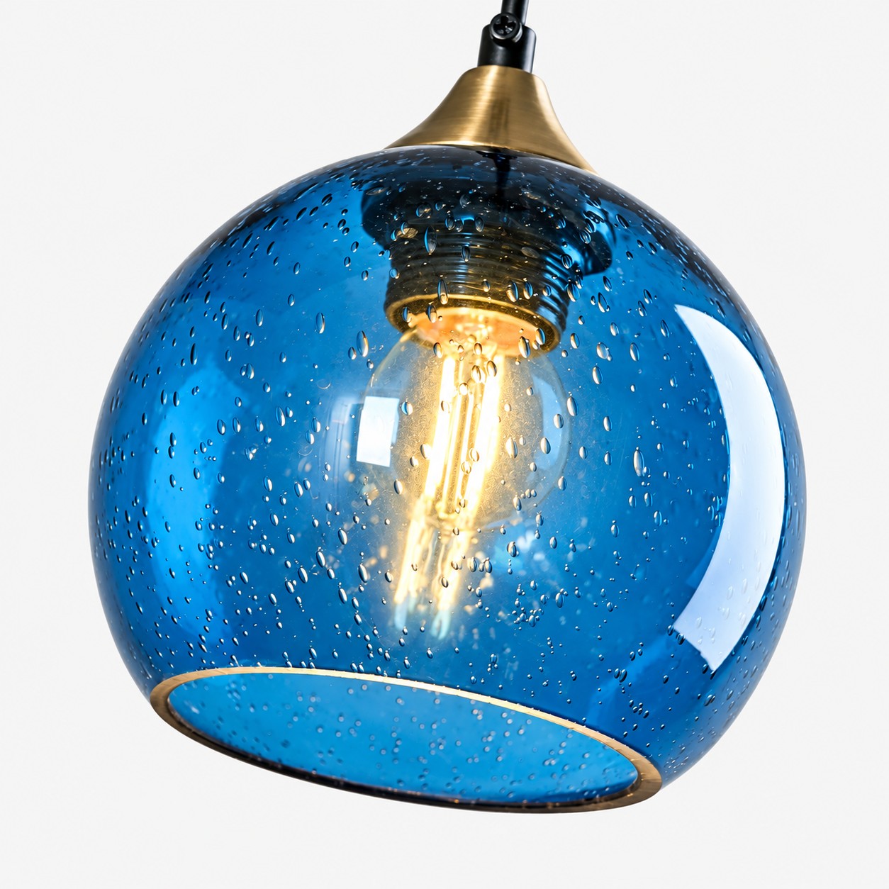 Blue bubble glass globe with glowing E26 bulb