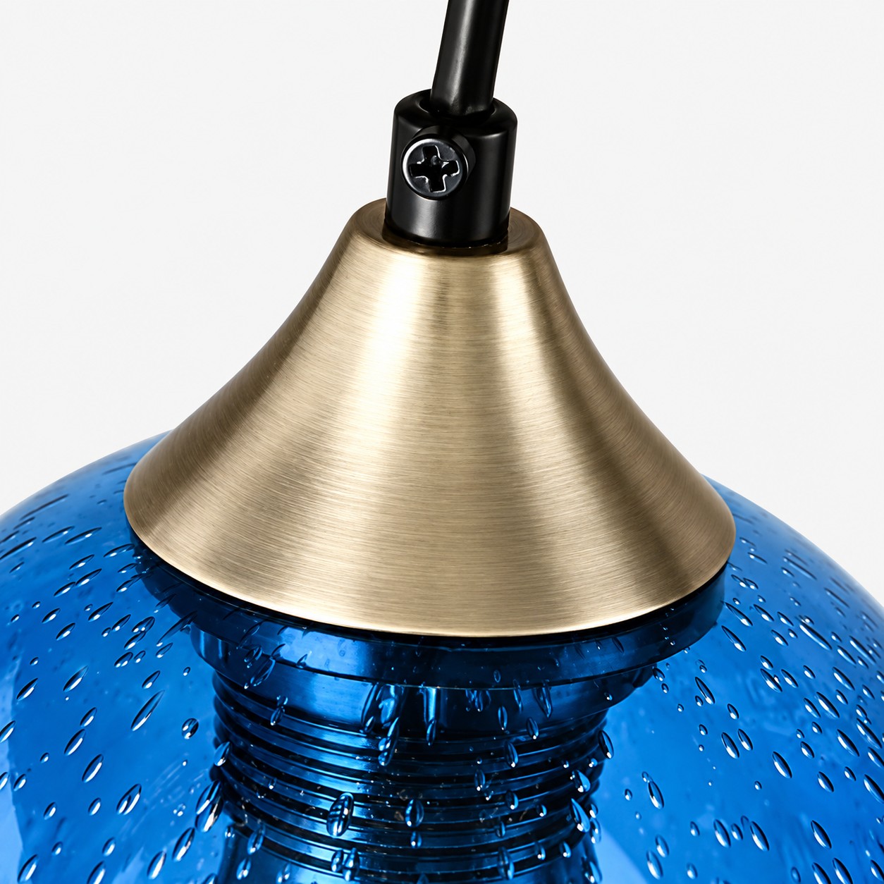 Close detail of the brass-toned socket and textured blue glass