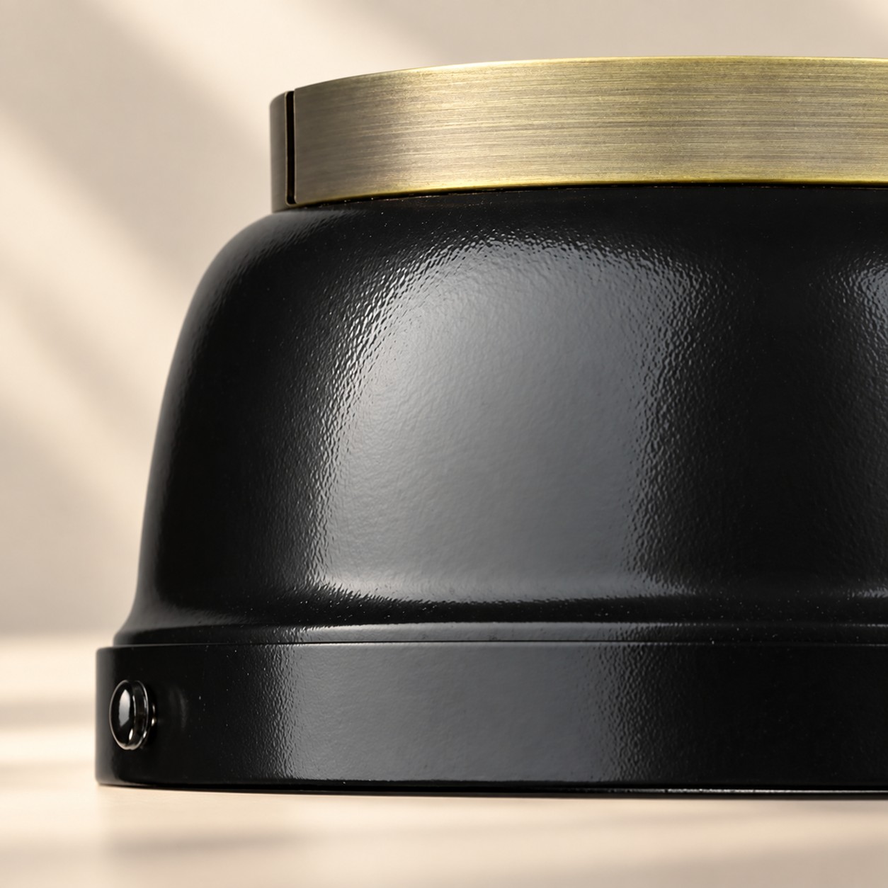 Close-up of textured metal dome with brass collar