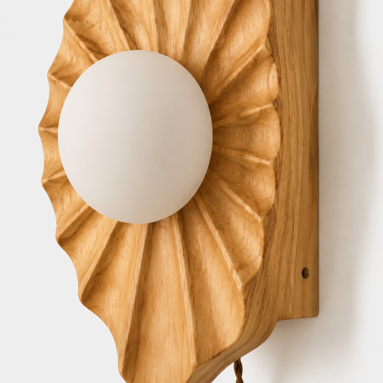 Front close-up of carved shell shape and round diffuser