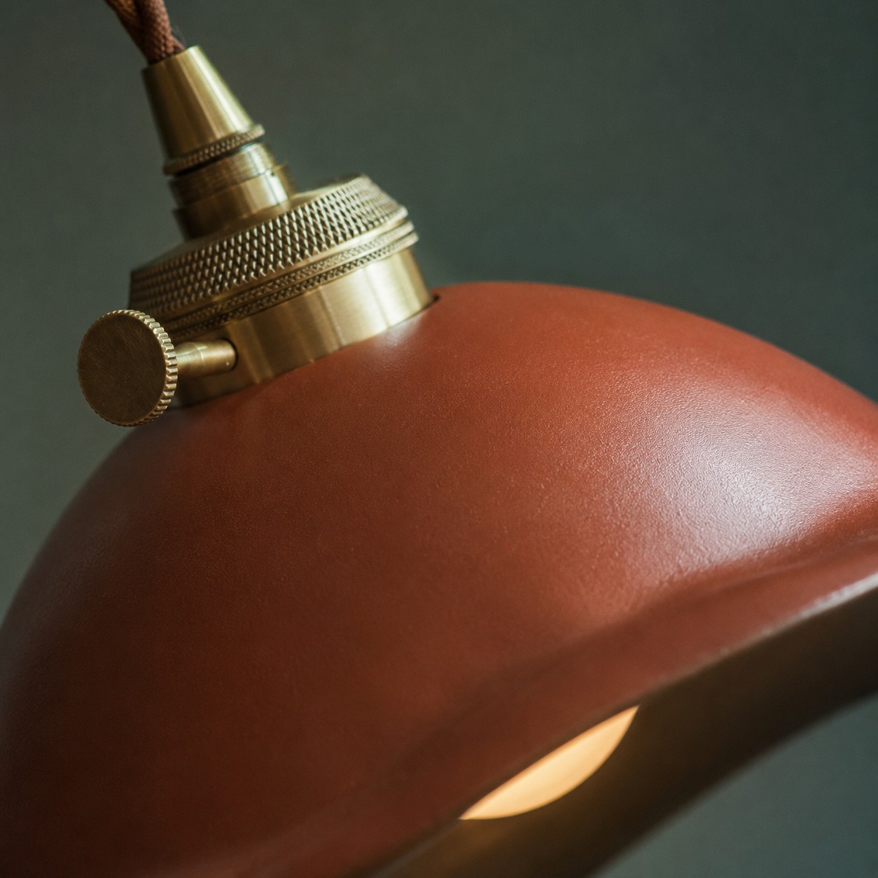 Detailed view of the brass-toned socket fitting and ceramic glaze