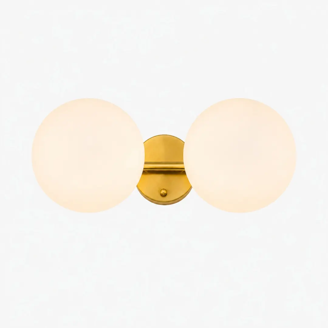 Gold two-light vanity light with milk glass globes