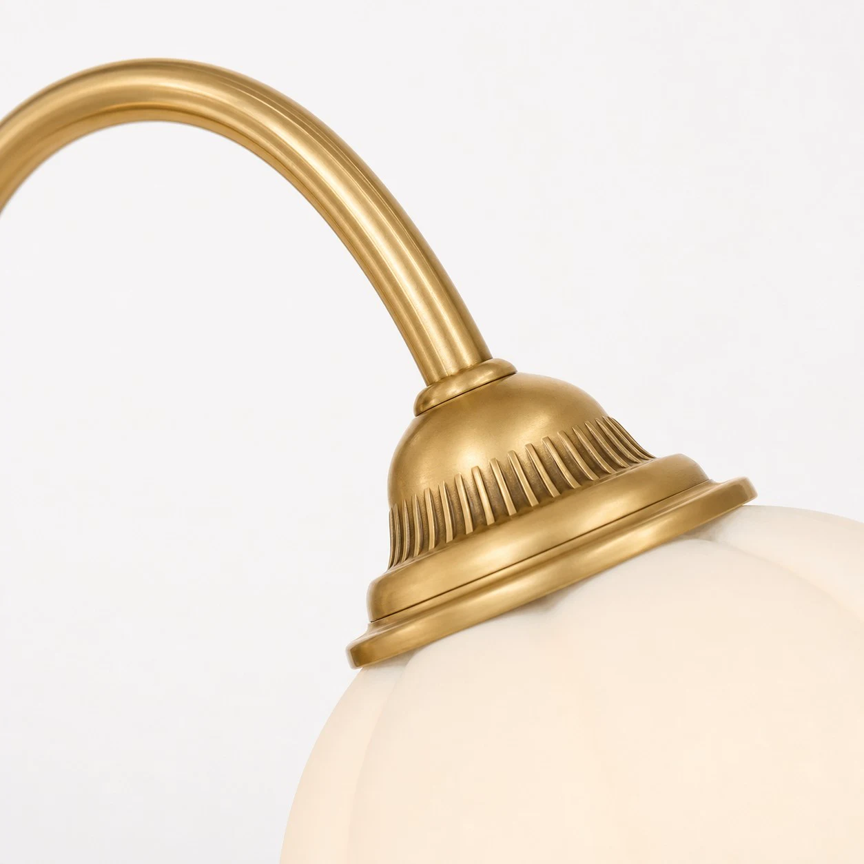 Brass arm and glass shade connection