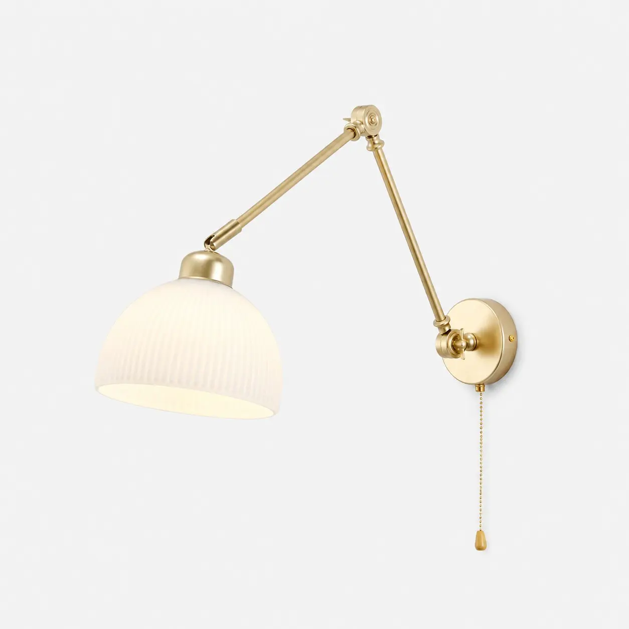 Luminária de parede com acabamento dourado e base fixa.