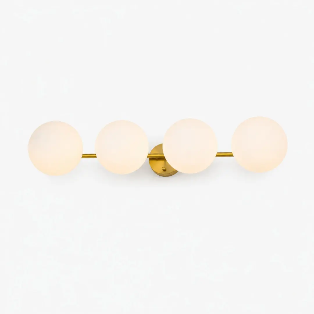 Gold four-light vanity light with milk glass globes