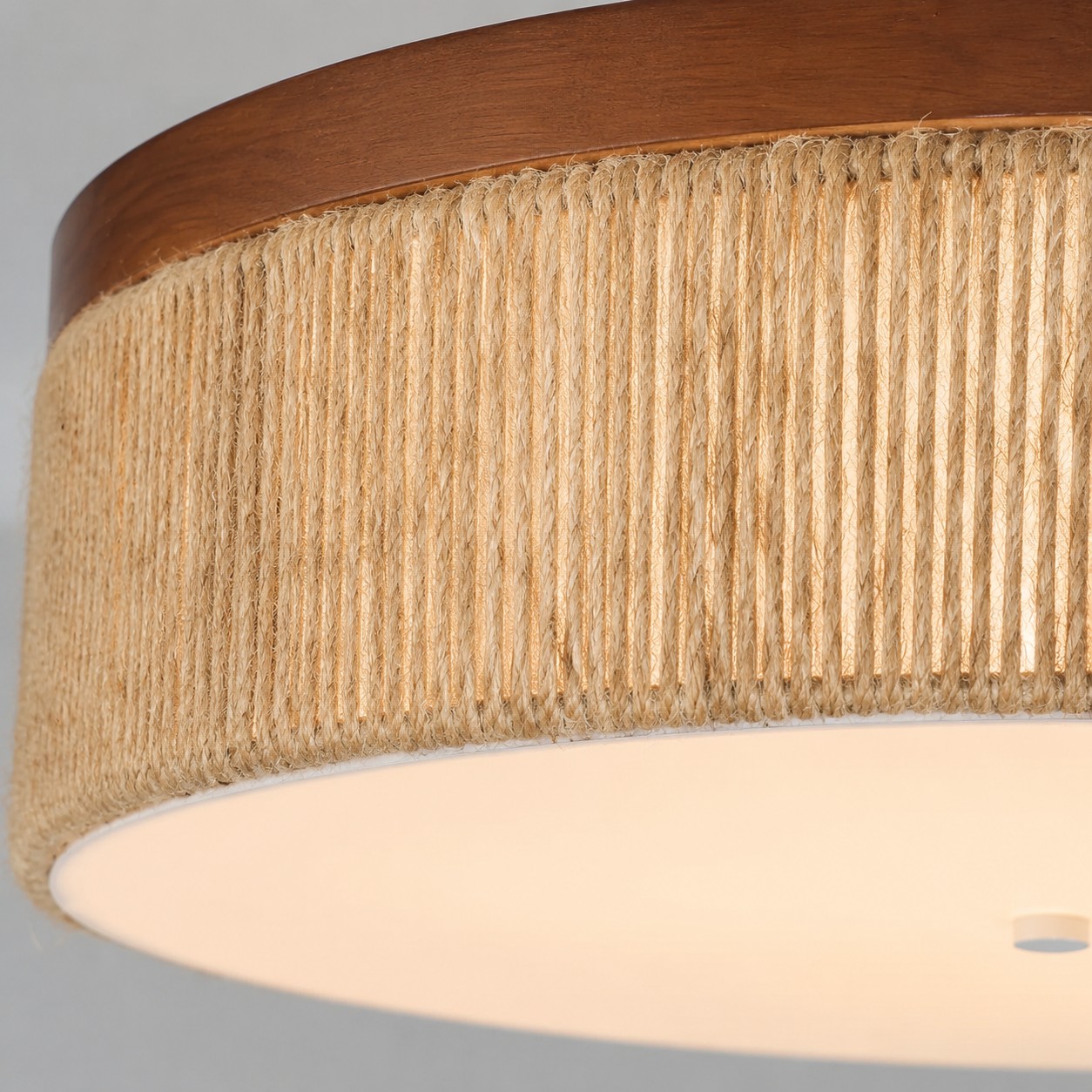Close view of the solid wood rim and woven rope ceiling light