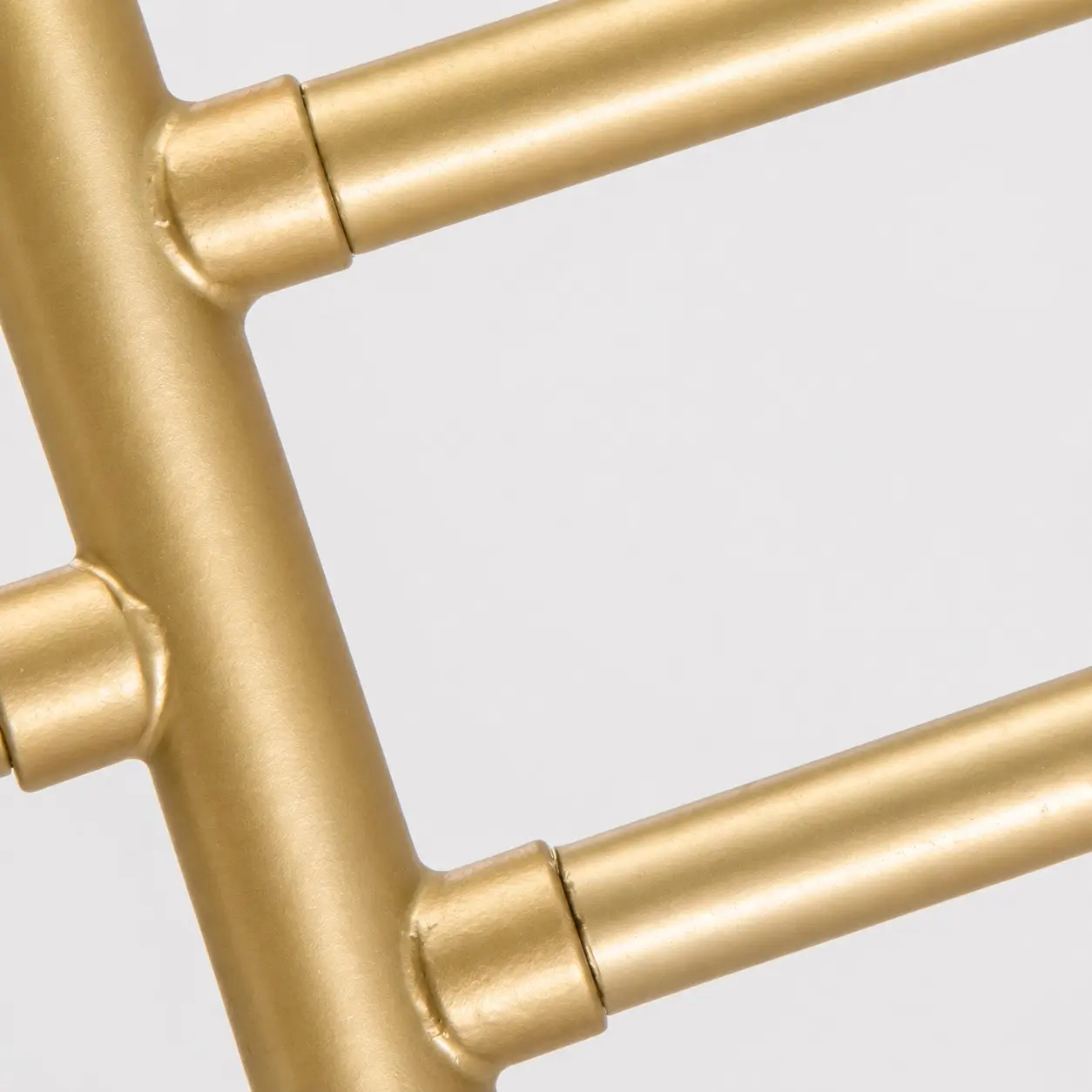 Close-up of the curved gold-tone metal frame