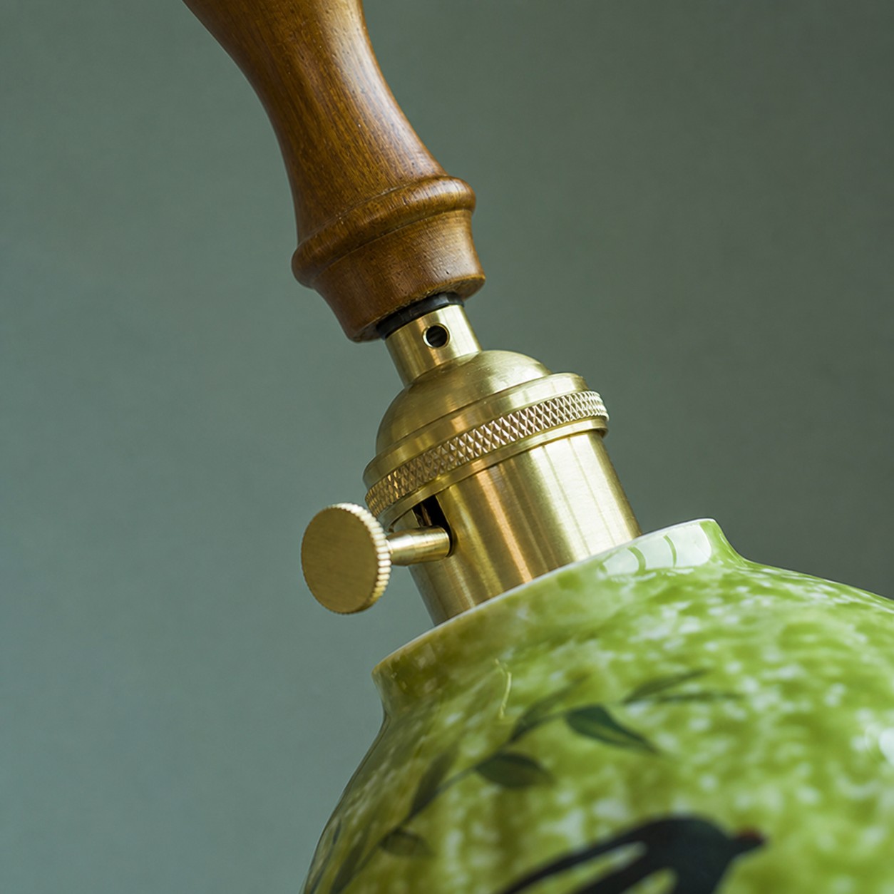 Turned wood grip and brass-tone pendant hardware detail