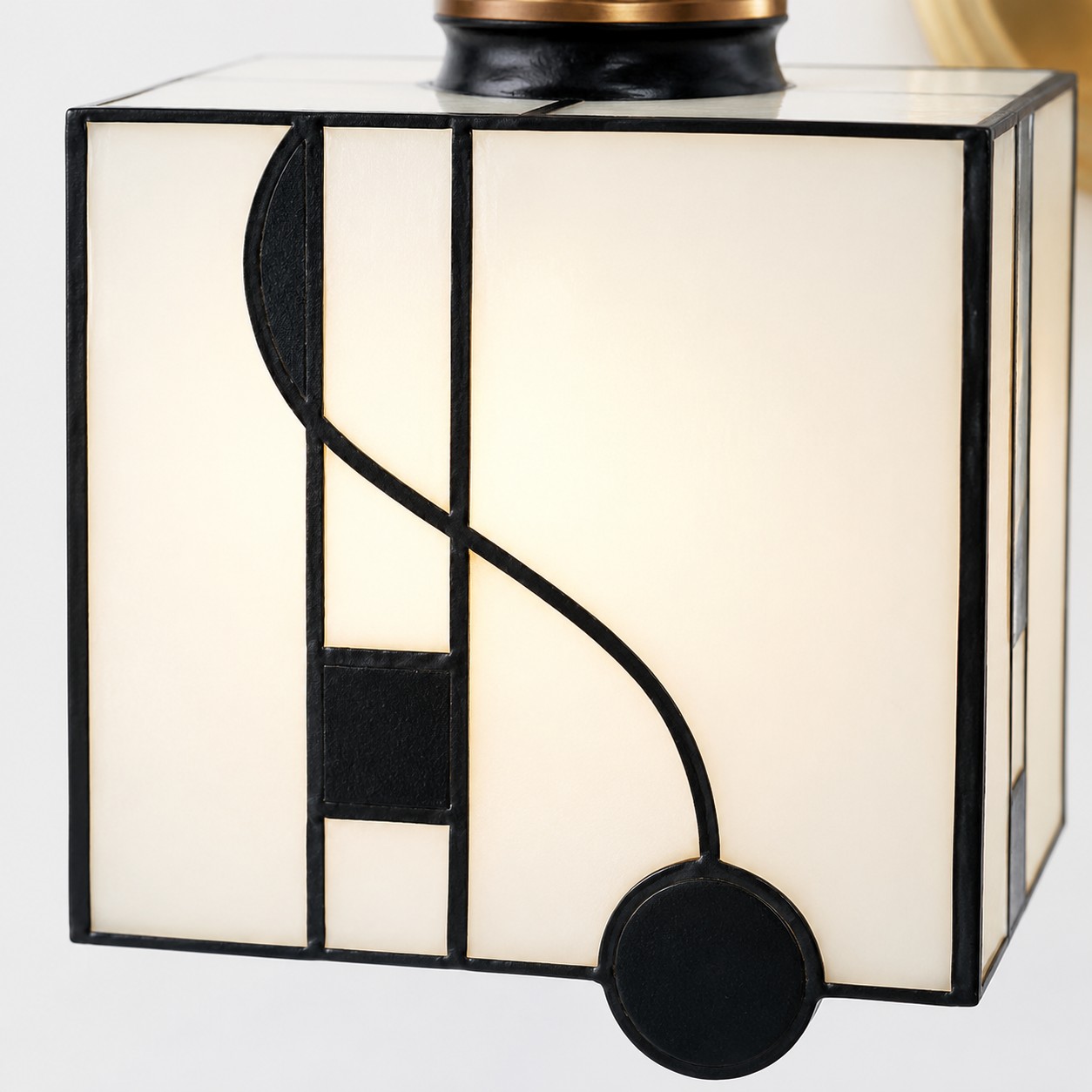 Dettaglio dell'applique da parete con paralume in vetro a forma di nota musicale.