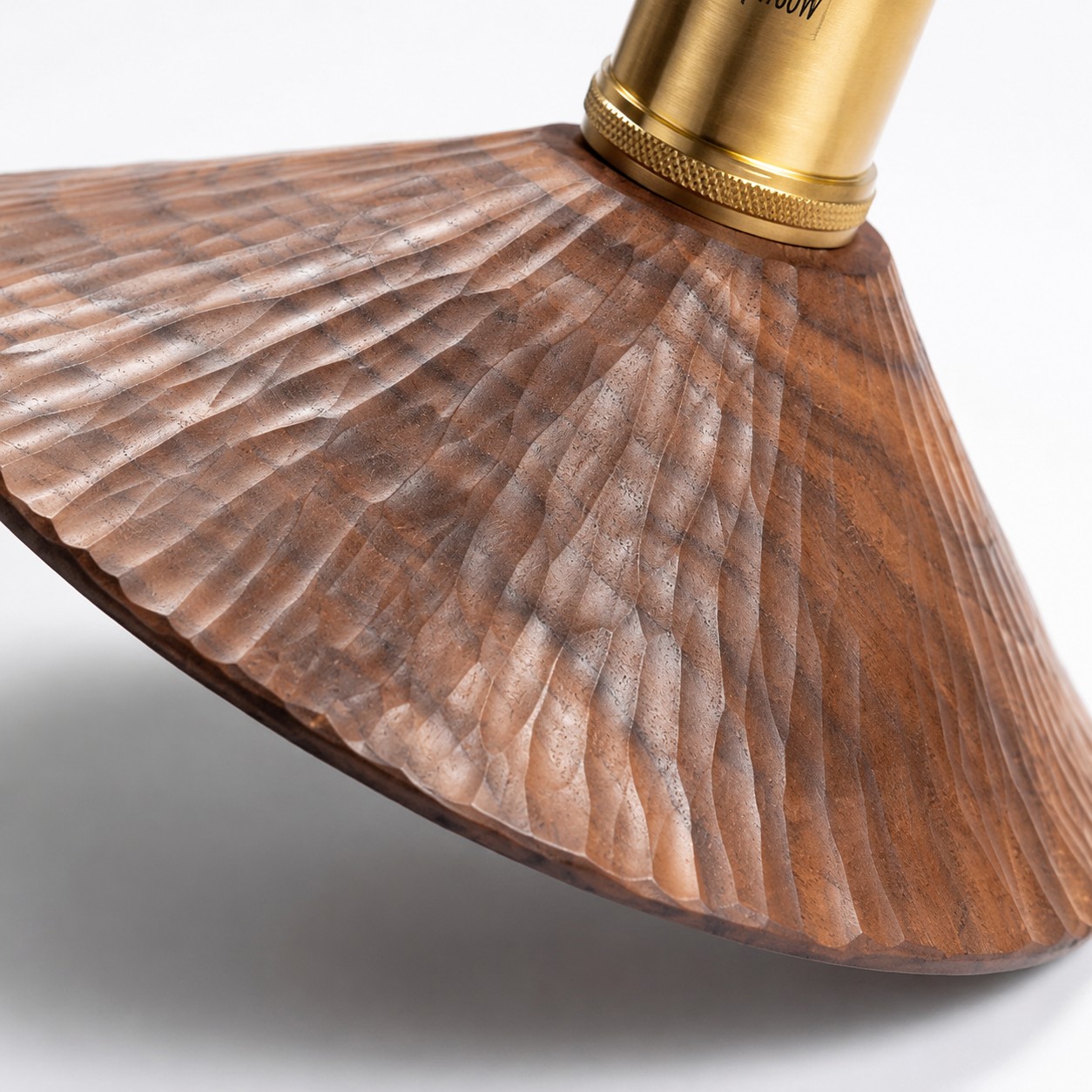 Close view of the hand-carved wood grain and brass fitting