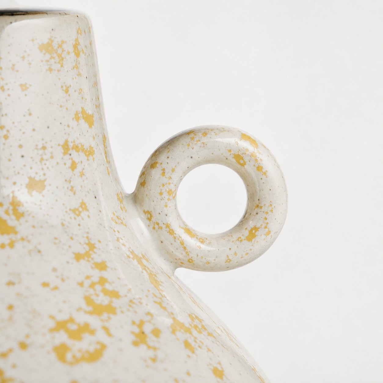 Close view of circular side loop detail on ceramic table lamp