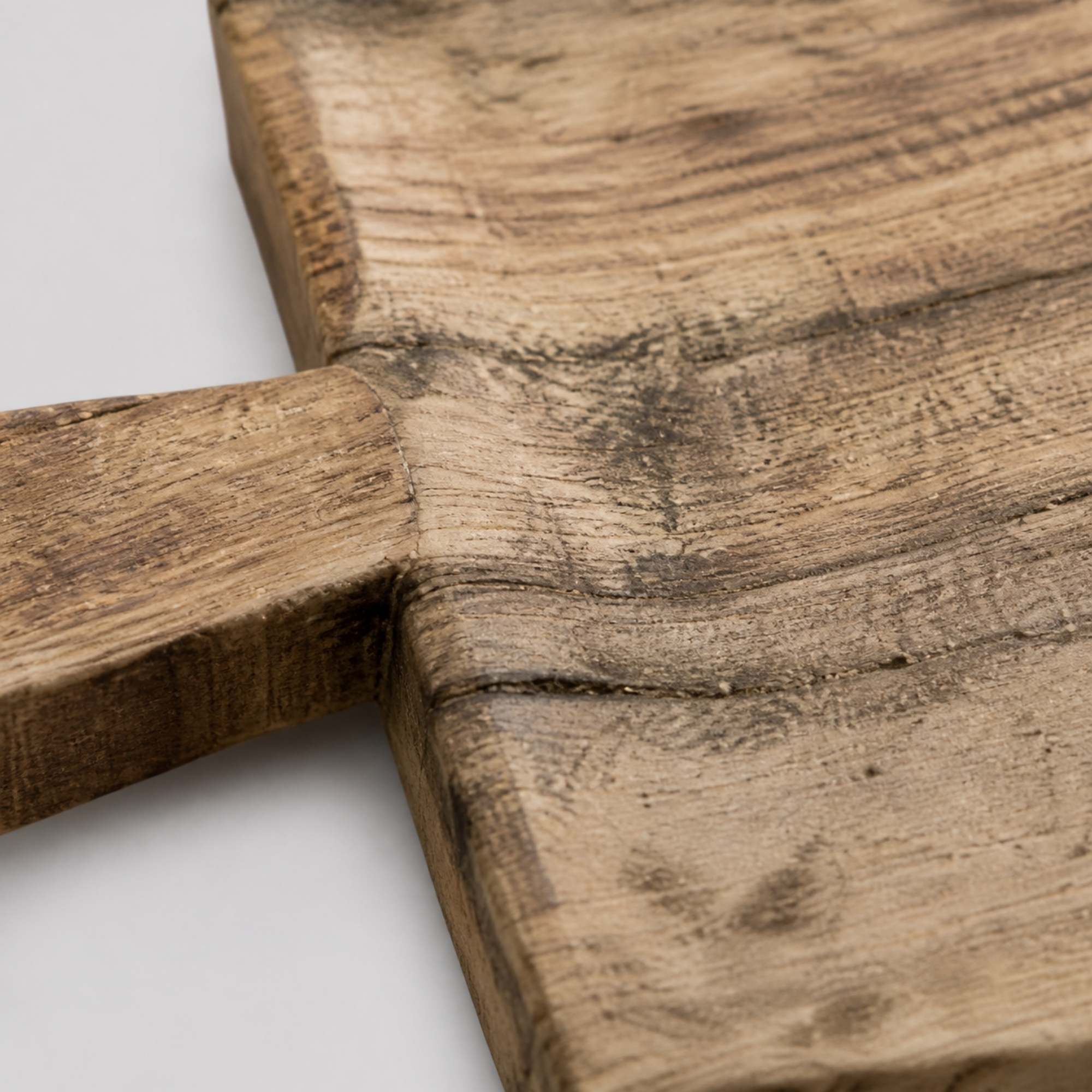 Close-up of carved rim and reclaimed wood grain