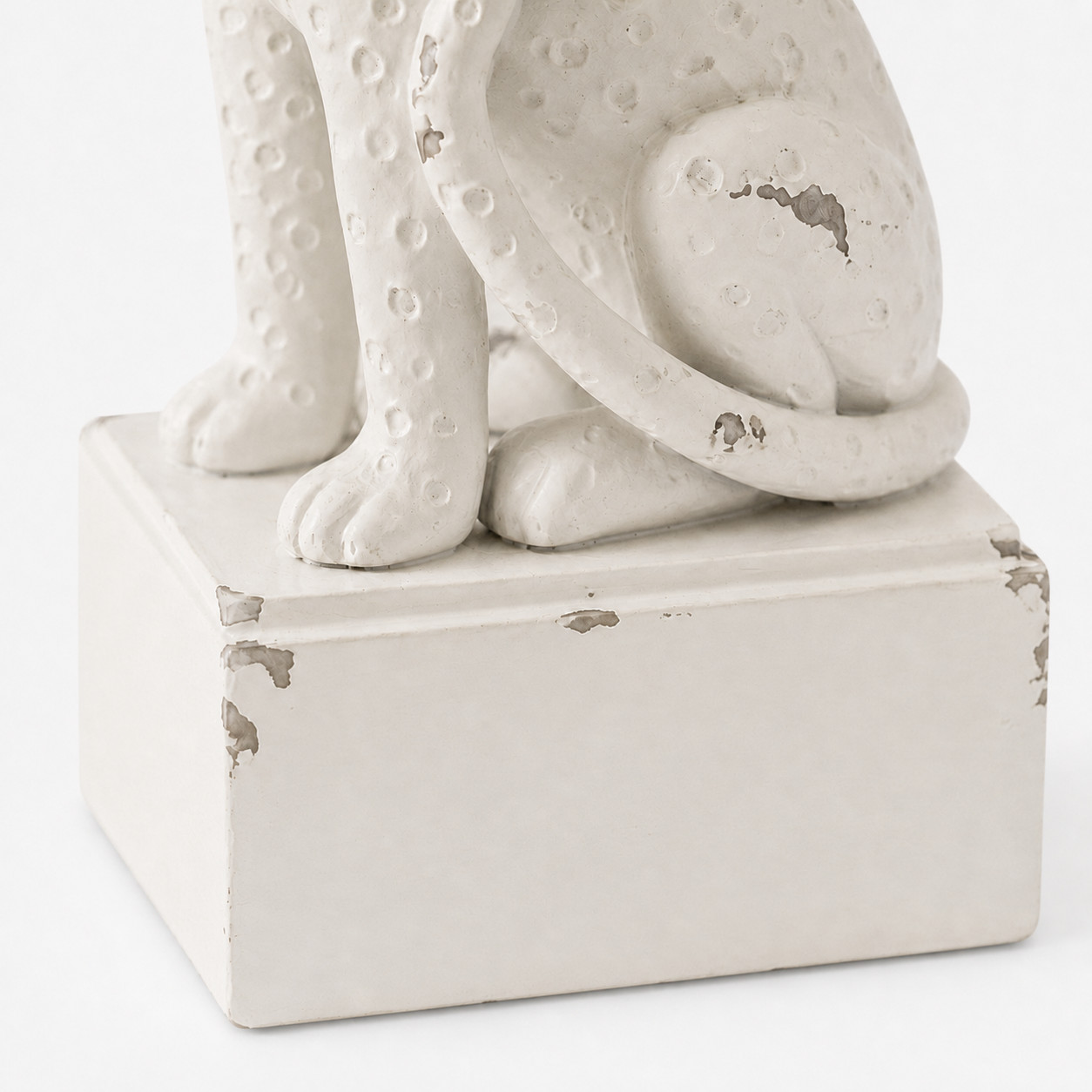 Close-up of the white pedestal base with distressed edges