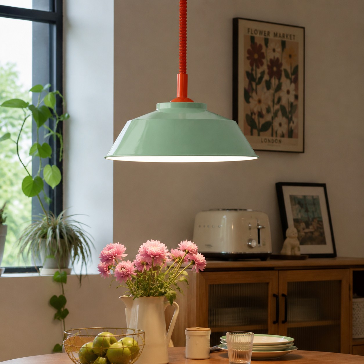 Mint green and red pendant above a dining table