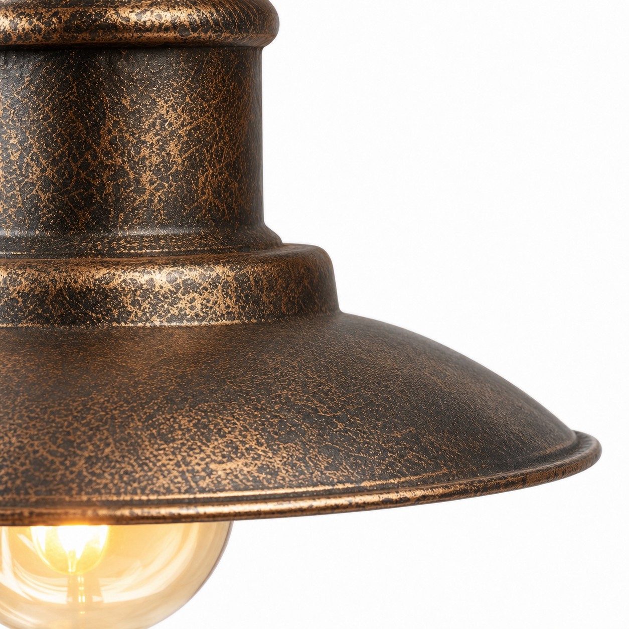 Close view of antique brass wall sconce metal shade texture