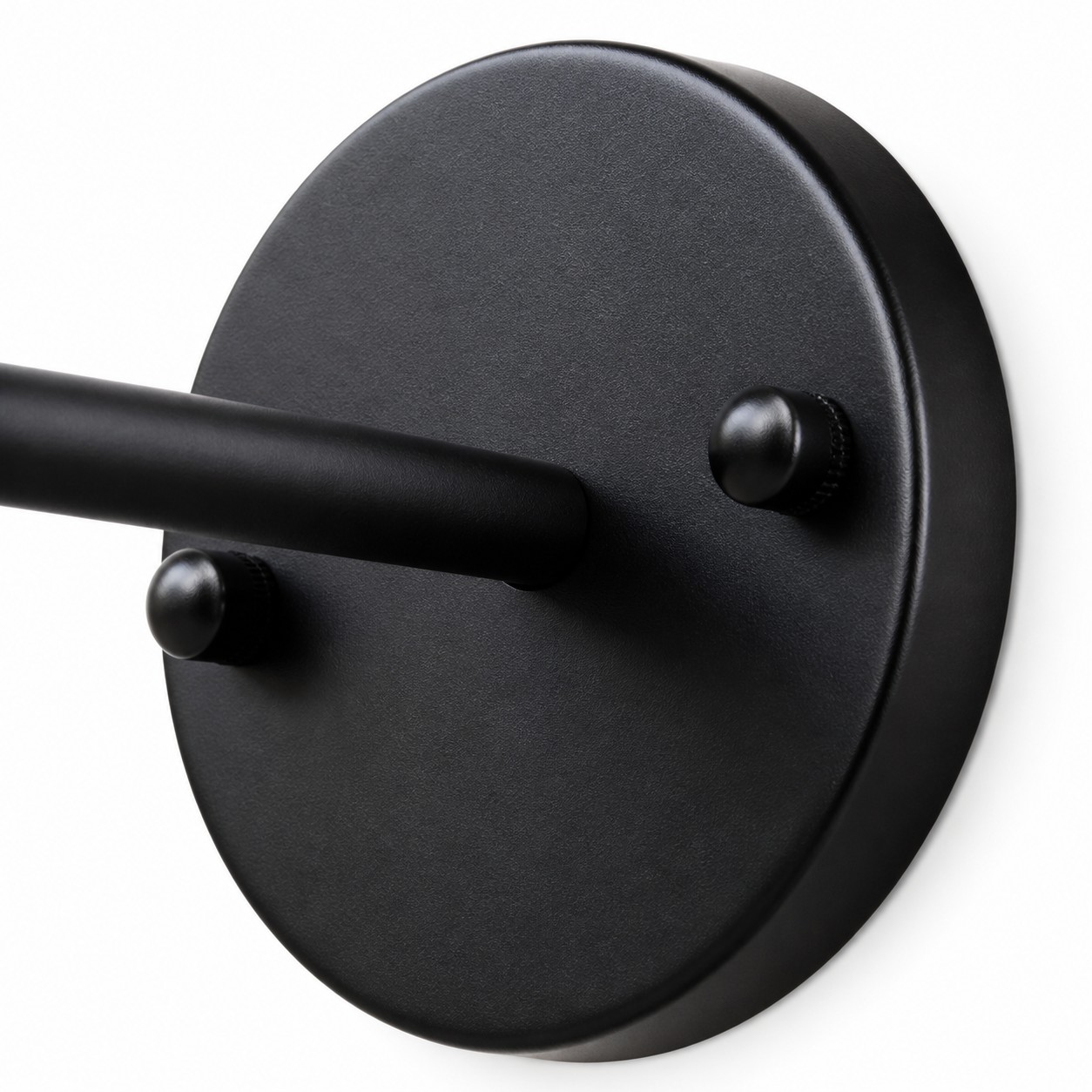 Close view of black round wall plate and straight arm connection