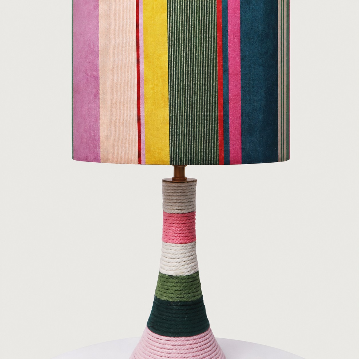 Close view of the colorful striped fabric shade and thread-wrapped base
