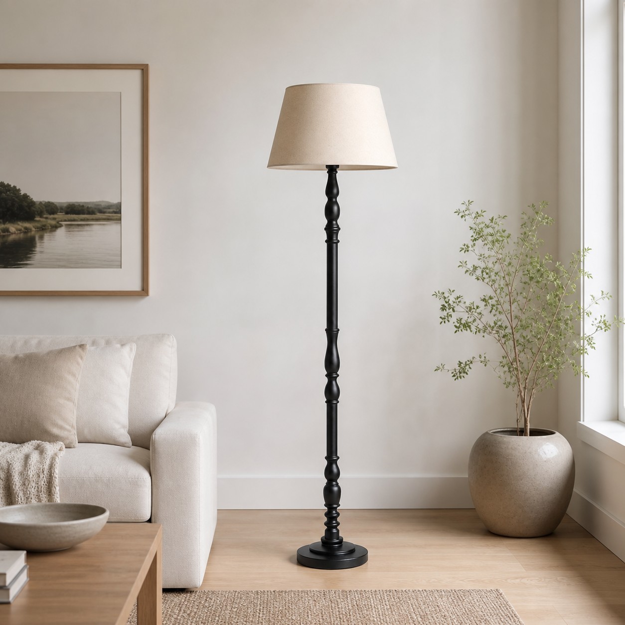 Black turned-wood floor lamp beside a light upholstered chair in a living room