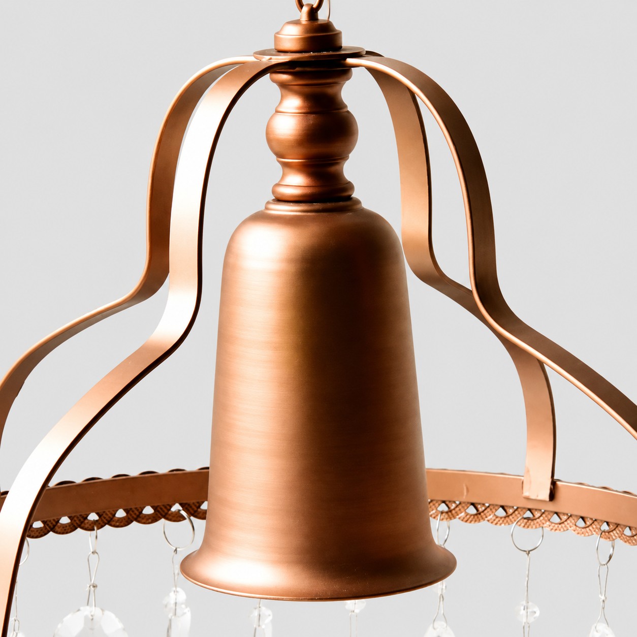 Close view of the chandelier's copper-toned metal crown