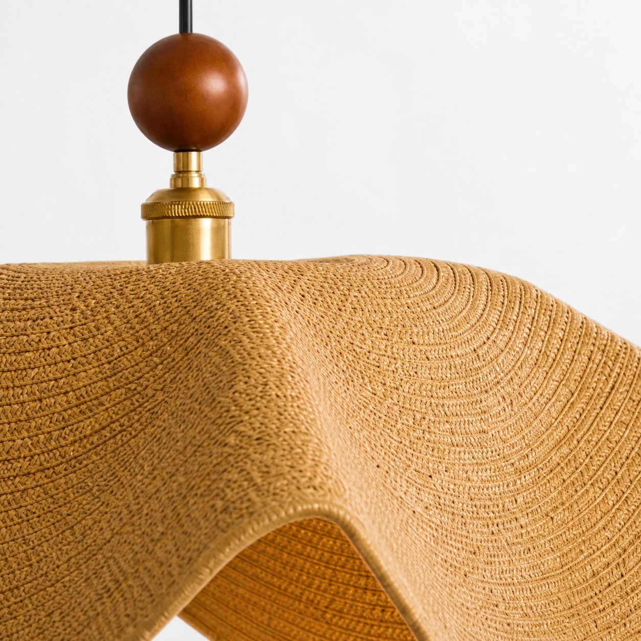 Close view of the brown woven shade and wood-and-metal fitting