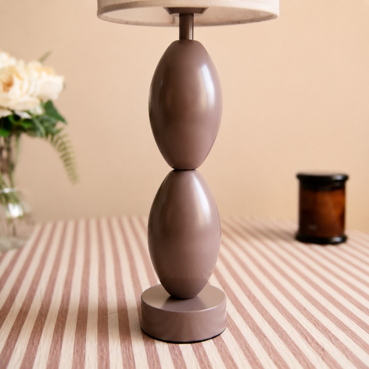 Rounded stacked taupe brown table lamp base detail