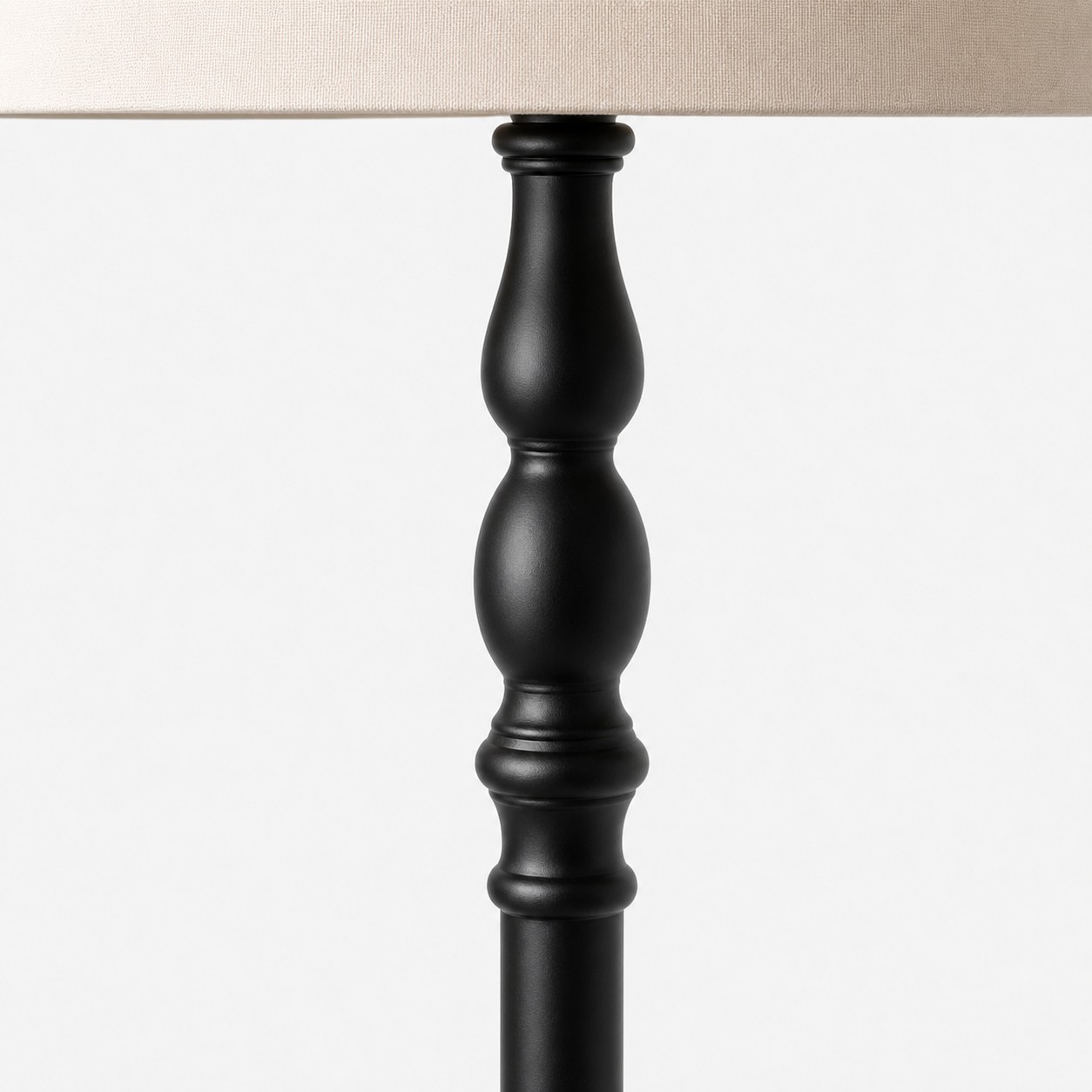Close view of the black turned-wood stand