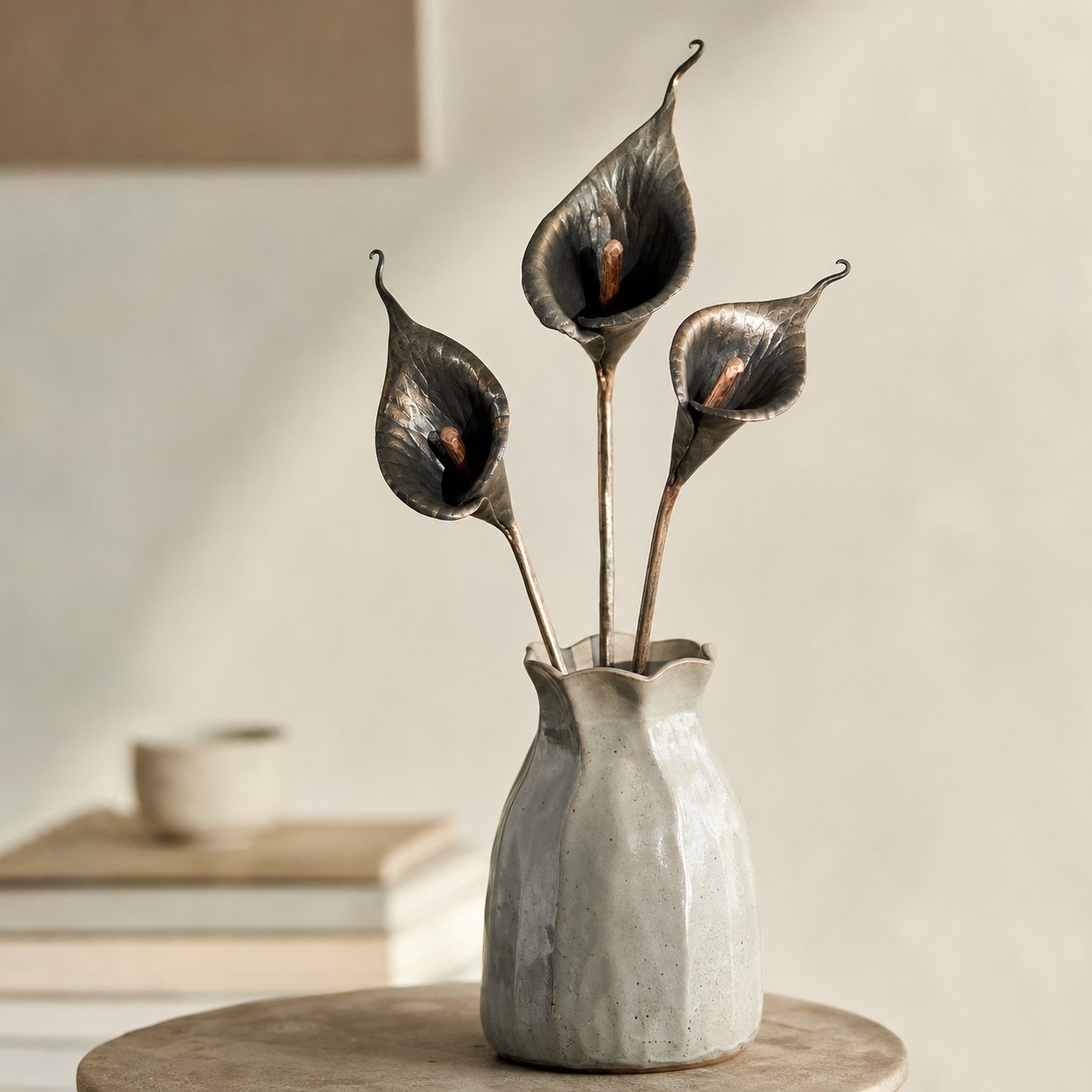 Iron calla lily stems styled in a vase in a calm interior scene