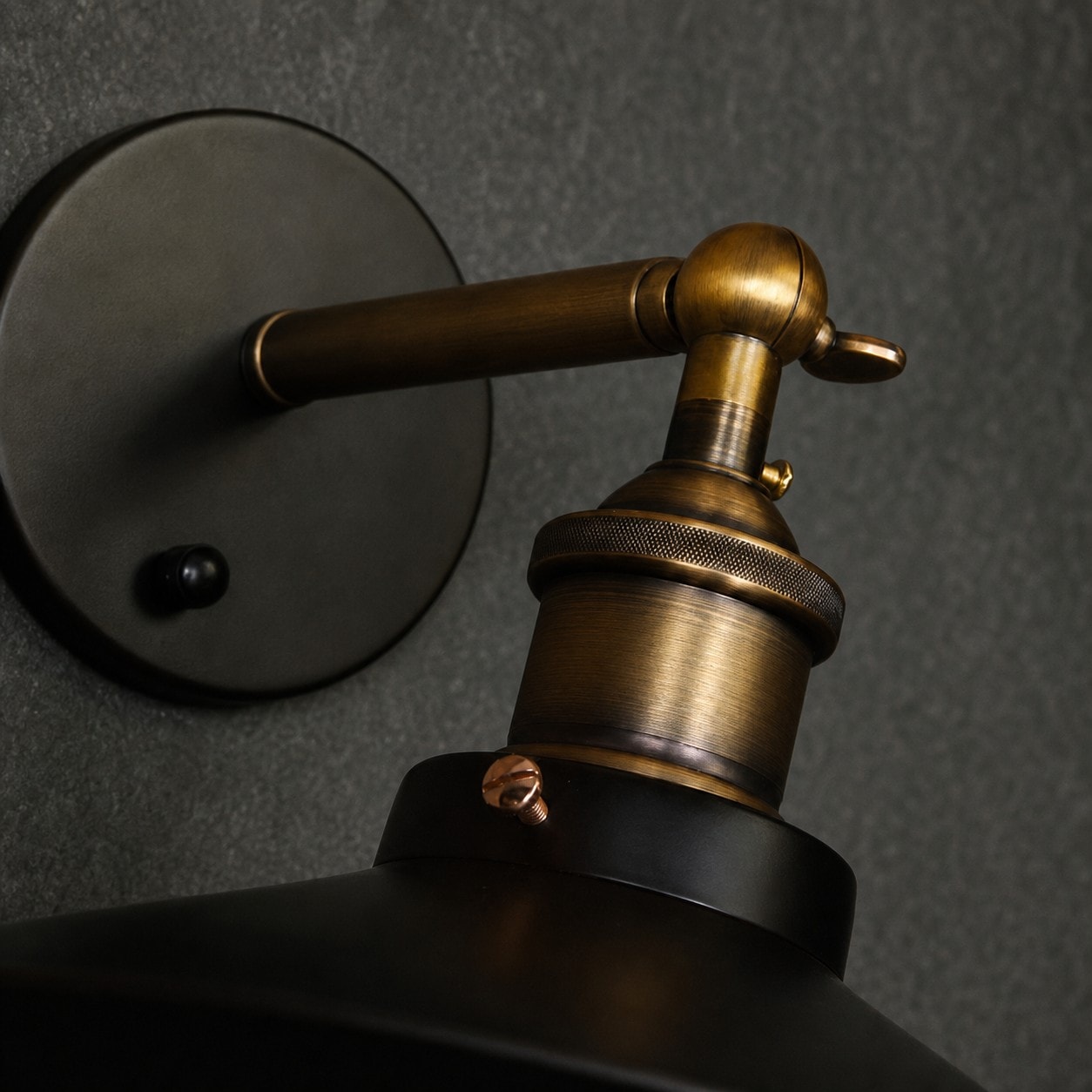Wall plate and antique brass-tone arm detail