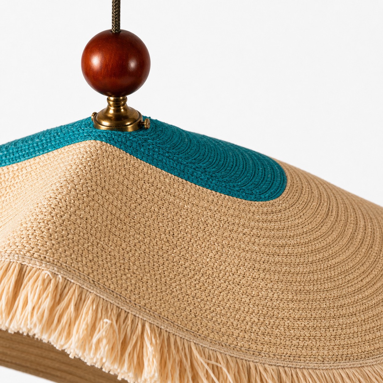 Close view of the ivory woven shade with fringe trim