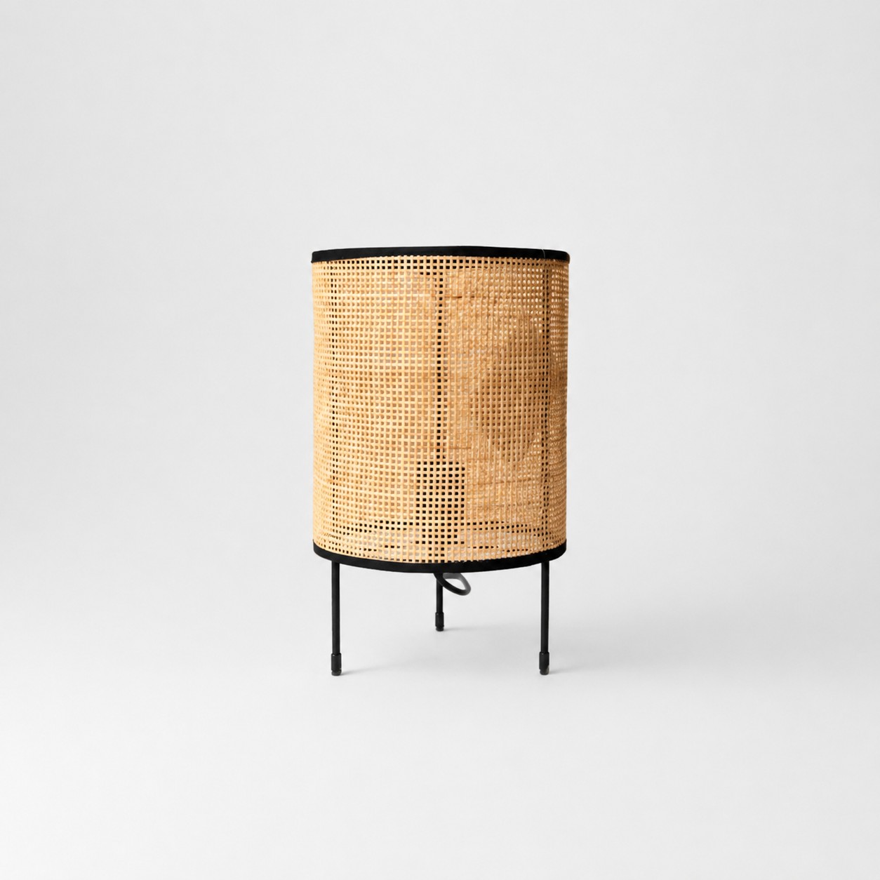 Open weave natural rattan LED table lamp on gray background