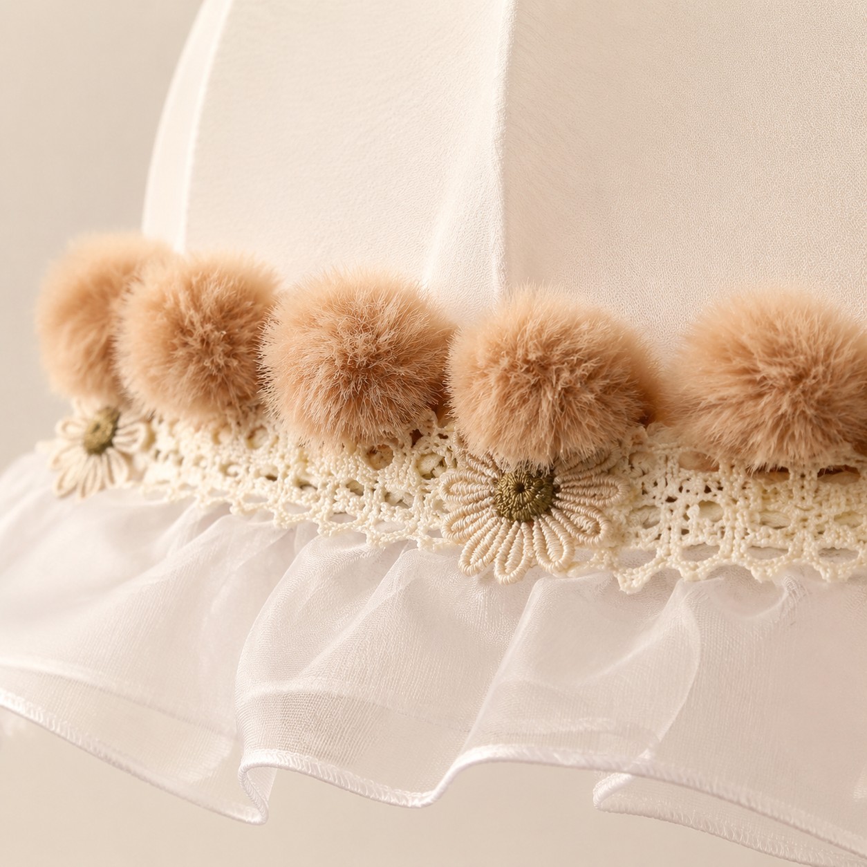 Warm camel pom-pom and floral lace trim